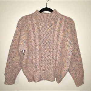 En Creme donegal cable knit mock neck sweater.